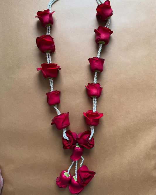 Red rose with double string of pearls garland